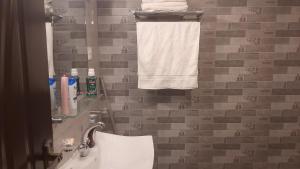 a bathroom with a sink and a toilet and a towel at LvL 50 in Murree +41 photos