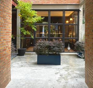 a store front with potted plants in front of it at The Sayla hotel(Baan Sayla) in Chiang Mai