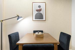 a dining room table with chairs and a lamp at Braga Center Apartments - São Vicente in Braga
