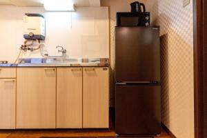 a kitchen with a stainless steel refrigerator and a sink at miyu 灵谷 デザイナーズ和の空間友達グループ最適ゲーム室完備新しいオープン in Osaka