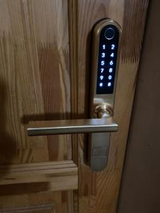 a close up of a door handle with a remote control at Happy rooms in Ventspils