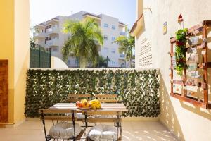 a table with fruit on it next to a building at Home2Book Dream Apartment Blue Coast Sun Fañabé in Adeje
