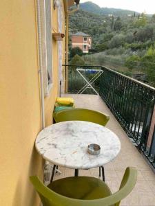 einen Tisch und Stühle auf einem Balkon mit Aussicht in der Unterkunft Nenè al mare appartamento con posto auto wifi e idromassaggio in Santa Margherita Ligure