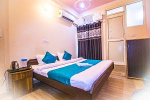 a bedroom with a large bed with blue pillows at Triple One Hostel Tapovan Rishikesh in Rishīkesh