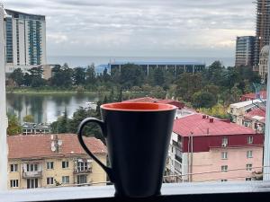 a coffee cup sitting on a window sill at Babi Home in Batumi
