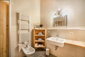 a bathroom with a sink and a toilet and a mirror at Grushof App Köpfl in Sluderno