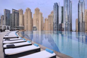 a swimming pool with a view of a city at Address Dubai Marina Residences by Qstay in Dubai