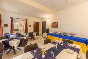 a room with tables and chairs with blue and yellow table cloth at WelcomHeritage Kalyan Bhawan Hotel in Jaisalmer