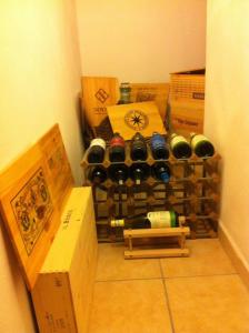 a bunch of wine bottles in a room with boxes at Villa Oliveto apartments in Oliveto Lario