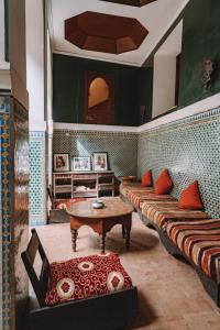 a living room with two beds and a table at Equity Point Marrakech in Marrakesh