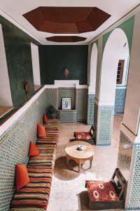 Zimmer mit Sofa, Tisch und Stühlen in der Unterkunft Equity Point Marrakech in Marrakesch