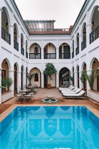 an indoor swimming pool in a building with a large building at Equity Point Marrakech in Marrakesh