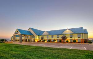 a large yellow building with a blue roof at Days Inn by Wyndham Tunica Resorts in Tunica Resorts