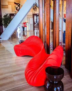 a row of red seats in a building at Andaz Capital Gate Abu Dhabi - a concept by Hyatt in Abu Dhabi
