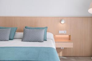 A bed or beds in a room at Petit Sagitario Adults only