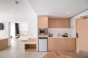 A kitchen or kitchenette at Petit Sagitario Adults only