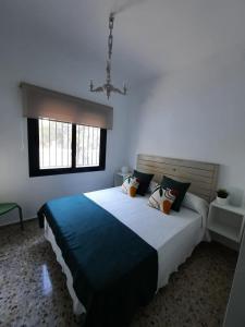 Un dormitorio con una cama grande y una ventana. en La Garzona, en Andújar