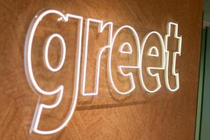 a neon sign that says open on a wooden wall at Greet Hotel Colmar in Colmar