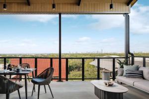 a living room with a large glass window at Origin Austin, a Wyndham Hotel in Austin