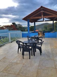 un grupo de mesas y sillas en un patio en Pousada Trilha do Sol, en Pirenópolis