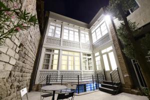 a table and chairs in front of a building at Old Gold Anteon in Tbilisi City