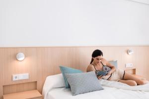 A bed or beds in a room at Petit Sagitario Adults only