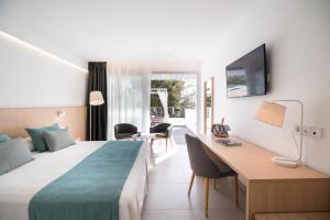 A bed or beds in a room at Petit Sagitario Adults only