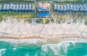 Meliá Vinpearl Cam Ranh Beach Resort في كام رنه: منظر علوي للشاطئ والمحيط