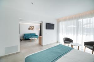 A bed or beds in a room at Petit Sagitario Adults only