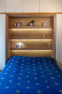 a bed with a blue comforter in a room at New Sweet One in Krakow