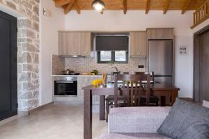 a kitchen with a table and a dining room at villa on the sea in Ayía Marína