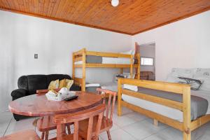 a living room with a table and a bunk bed at 25 Jacaranda Lodge & Backpackers in Pinetown