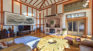 a living room with a table and a fireplace at ChungDam in Pyeongchang