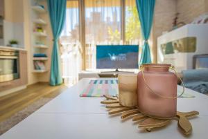 a living room with a table with two jars on it at Brand new Central apartment, 10 minutes to Center in Plovdiv