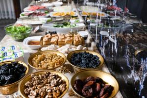 a buffet of food on a table with plates of food at Marokand Spa Hotel in Samarkand