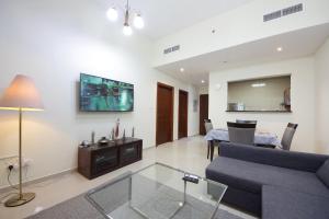 a living room with a couch and a table at Premium Furnished 1 BHK in La Vista 3, Silicon Oasis in Dubai