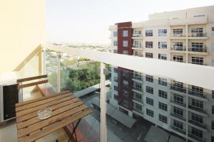 a balcony with a bench and a building at Premium Furnished 1 BHK in La Vista 3, Silicon Oasis in Dubai
