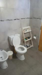 a bathroom with a toilet and a sink at CASA DE CAMPO in Helvecia