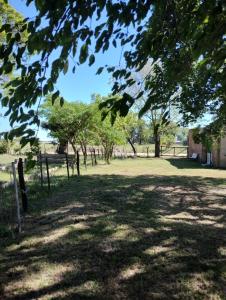 a park with trees and a fence in a field at CASA DE CAMPO in Helvecia