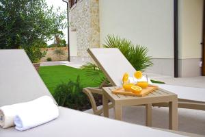 a patio with a painting and a table with oranges on it at Villa Julija in Rasopasno