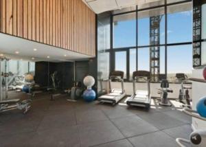 a gym with treadmills and machines in a large room at New! Great Value - Skytower center of CBD in Brisbane