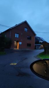 una gran casa de ladrillo con una calle delante de ella en Gîte La Renéade 