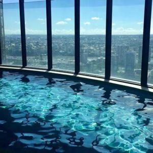 a swimming pool in a building with a view of the city at New! Great Value - Skytower center of CBD in Brisbane