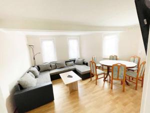 un soggiorno con un divano e un tavolo di Fully Equipped Spacious Worker Apartment a Apolda