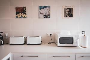 a kitchen counter with two toasters and a microwave at agroturismo Araize in Mungia