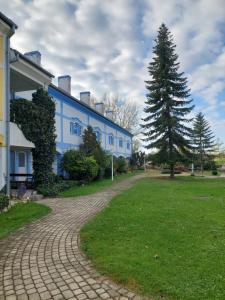 una casa con un árbol junto a una entrada de ladrillo en City Corner Thermal, en Mosonmagyaróvár