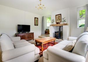 a living room with two white couches and a table at The Old Stores in Ipswich