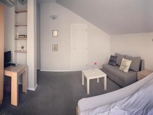 a living room with a couch and a table at Da Vinci Guesthouse in Varshets