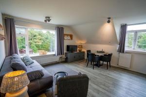 a living room with a couch and a table at De Ruige Hoogte in De Koog