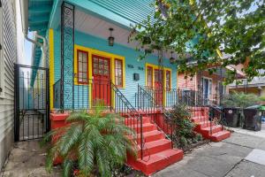 a colorful house with red doors on a street at Eat Your Cake Too in New Orleans